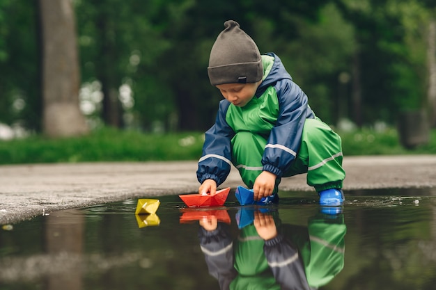 雨の公園で遊んで長靴で面白い子供 無料の写真