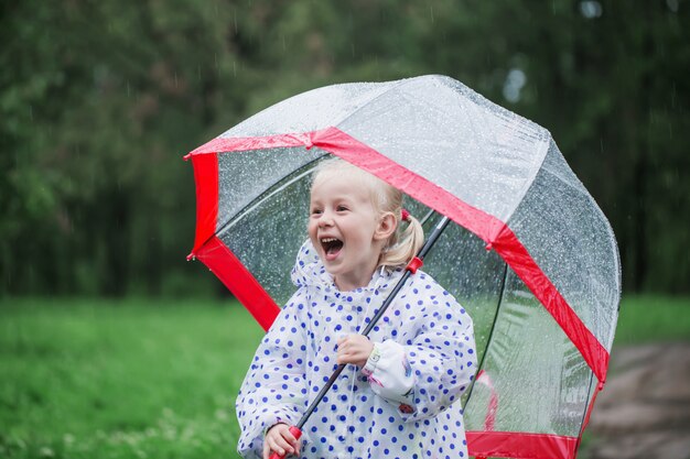 Premium Photo | Funny little girl with umbrella in rain