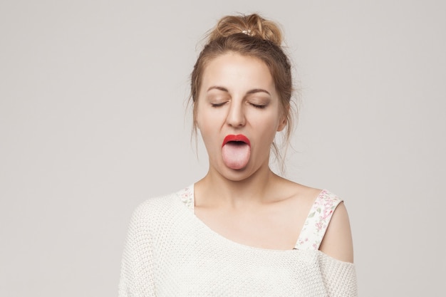 Premium Photo | Funny woman closed eyes and tongue out . studio shot ...