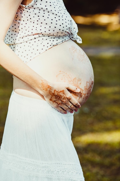 Premium Photo Future Mom In White Dress Holds Her Naked Tummy Painted