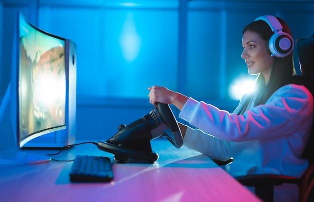 Premium Photo | The gamer girl playing video games at the dark room