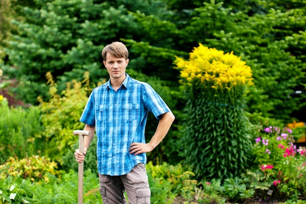 Premium Photo | Gardener standing with showel