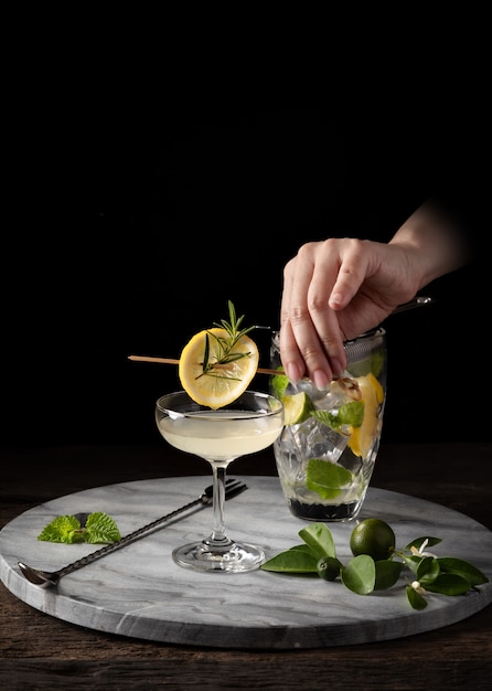 Premium Photo | Garnish cocktail with bartender hand on counter bar ...