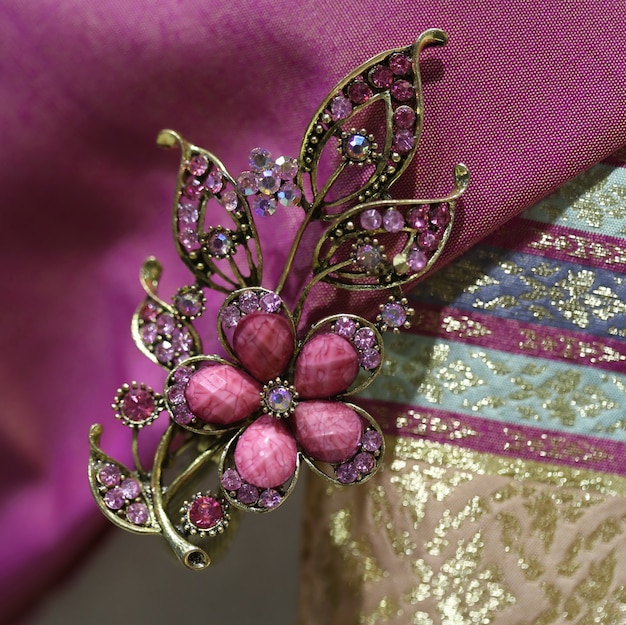 Premium Photo | Gems brooch on thai silk fabric