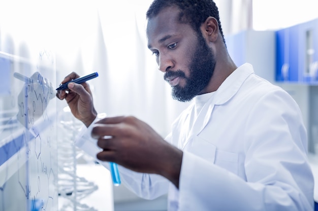 Premium Photo | Genius chemist. serious nice smart man standing in ...