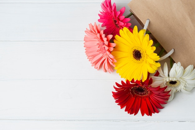 Gerbera flowers in a paper bag Free Photo