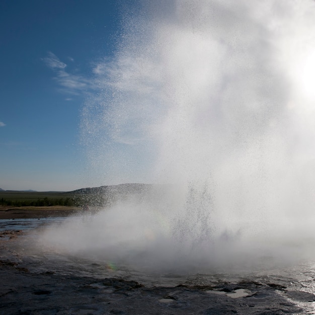 Premium Photo | Geyser erupting into steam and droplets