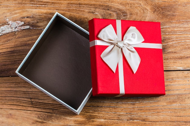 Gift box tied red ribbon with small red hearts printed on ...