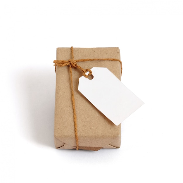 Gift box wrapped in brown recycled paper and tied sack rope with label tag Premium Photo