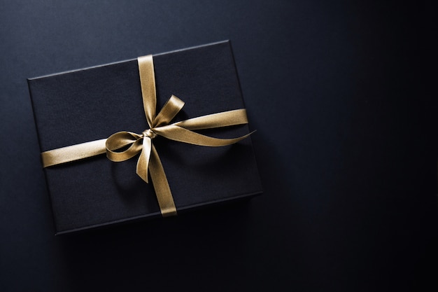 Premium Photo | Gift wrapped in dark paper on dark