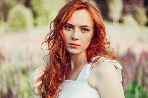 Premium Photo | Ginger red-headed girl with curly hair in the field