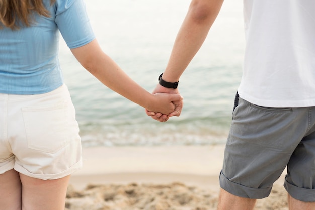 Free Photo Girl And Boy Holding Hands On The Beach Close Up