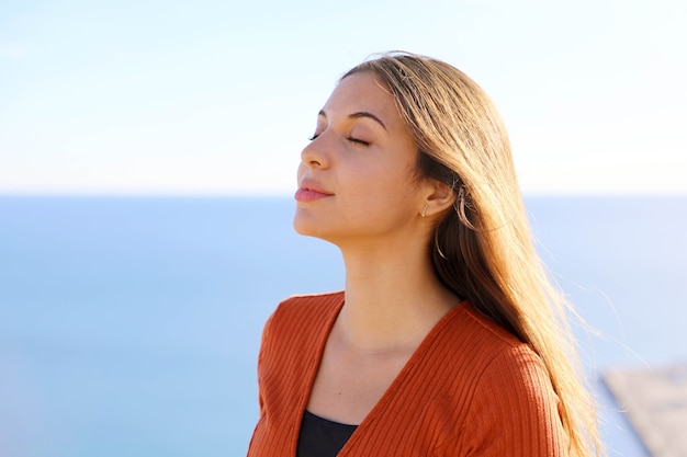 Premium Photo | Girl breathing fresh air with blue sea