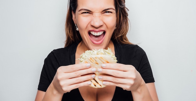 Premium Photo | Girl eating arepa