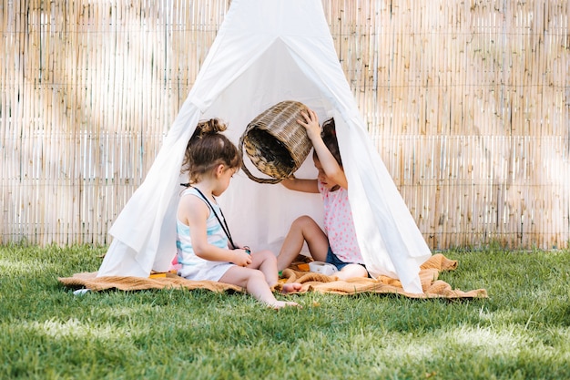 Free Photo | Girl emptying basket in tent