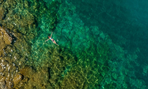 Premium Photo | Girl floating in the water, top view