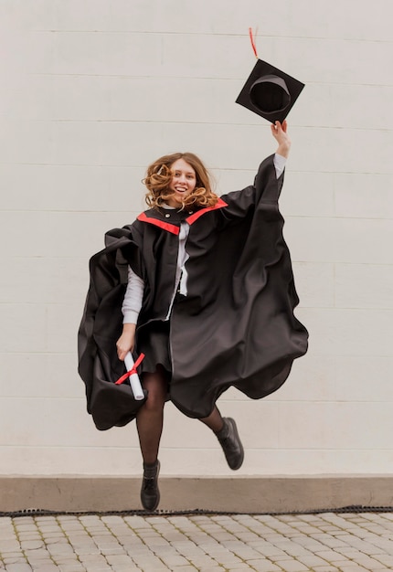 Premium Photo | Girl at graduation jumping