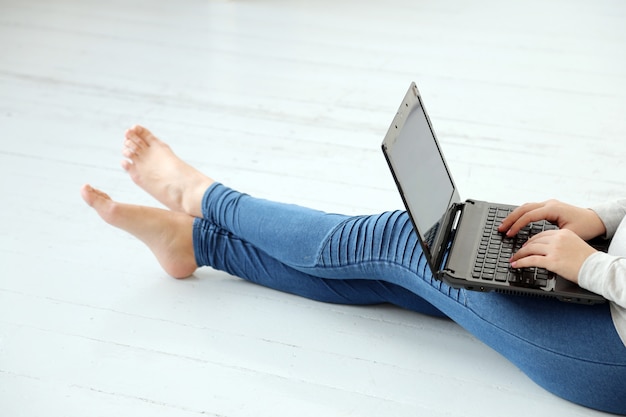 Girl on the ground with a laptop Photo | Free Download