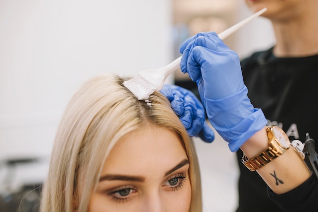 Girl in hairdresser parlor having coloring procedure Free Photo