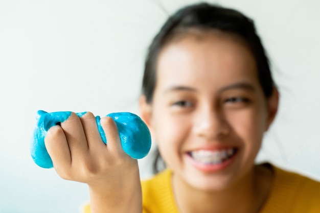 Premium Photo Girl Hand Holding Homemade Toy Called Slime