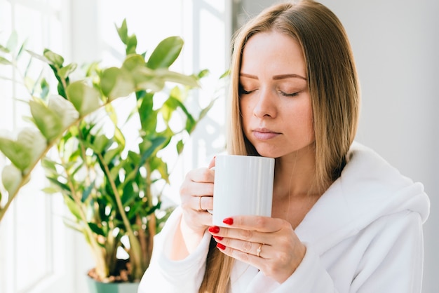 Free Photo | Girl having coffee at the bathroom