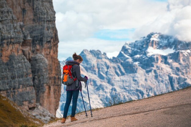 Premium Photo | Girl hiker at the mountains dolomites, italy. cinque torri