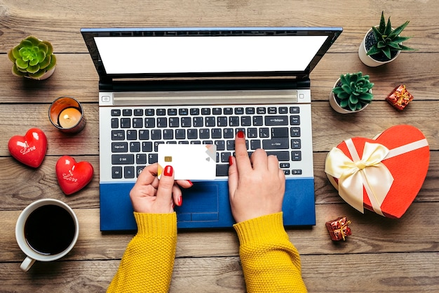 Premium Photo | Girl holds debit card, chooses gifts, makes purchase ...