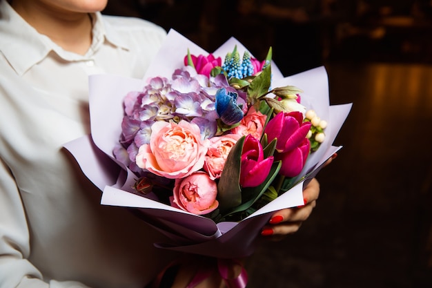 Premium Photo | The girl holds in her hand bouquet with multi-colored ...