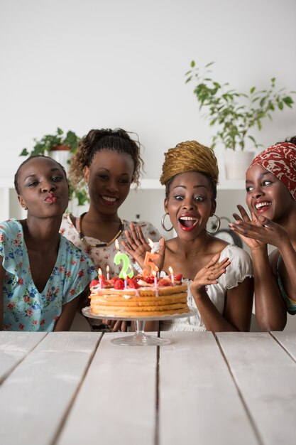 Premium Photo Girl Looking At Birthday Cake Surrounded By Friends