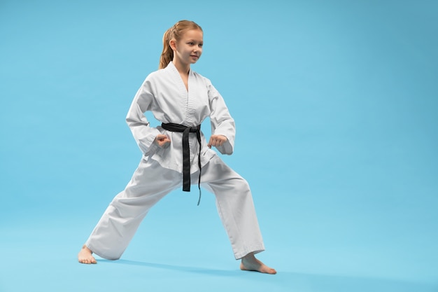 Free Photo | Girl performing defense position of karate.