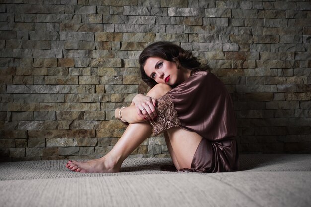 Girl Pinup With Brunette Hair And Retro Make Up With Red Lips In A