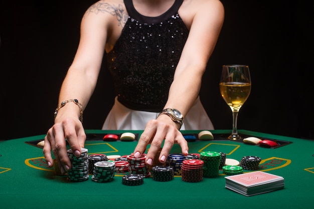 Premium Photo | Girl plays poker and raises bets with chips
