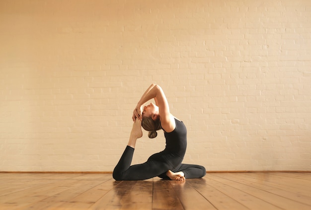 Girl practicing yoga positions Premium Photo