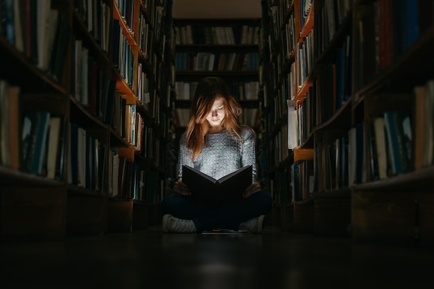 Premium Photo Girl Reading A Book In The Library Sitting On The Floor The Girl In The Library 2354