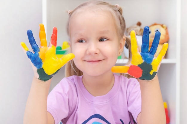 Premium Photo | Girl showing painted hands. hands painted in colorful ...