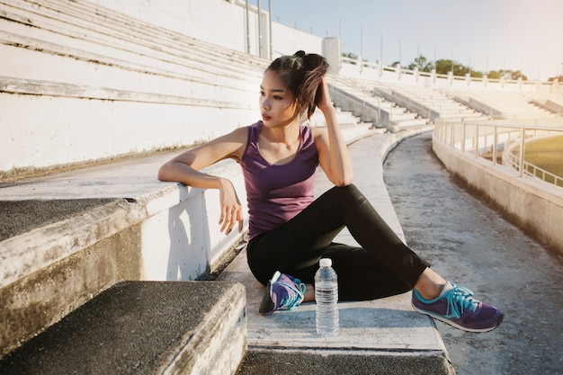 Girl sitting in the grandstand of a stadium Photo | Free Download