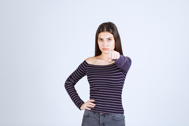 Free Photo Girl In Striped Shirt Showing Her Fist