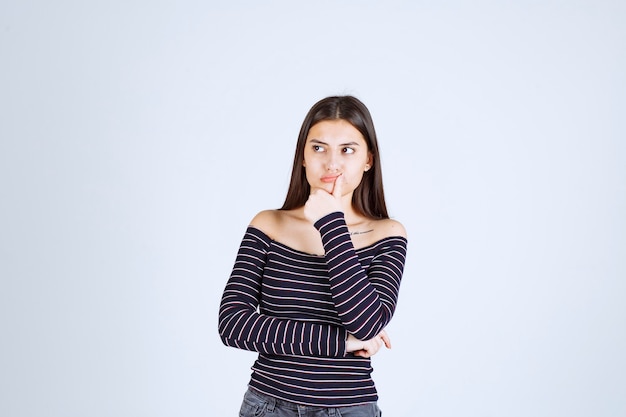 Free Photo | Girl in striped shirt thinking and analizing.