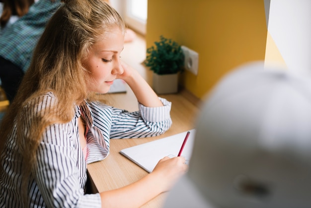 Girl studying in class doing exercises Free Photo