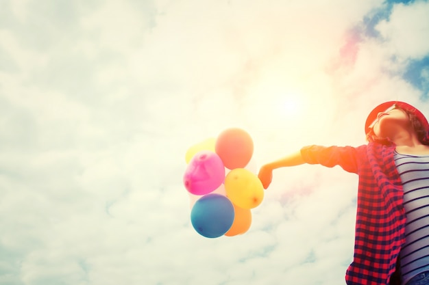Girl in sunset with balloons Free Photo