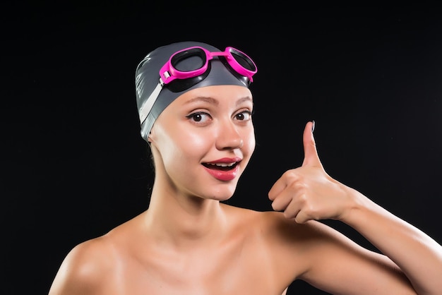 Premium Photo A Girl In A Swimming Cap Shows A Thumb