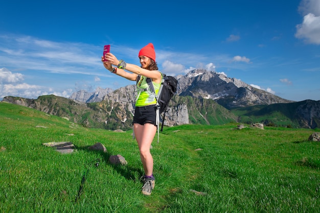 Premium Photo | Girl takes a selfie while hiking in the mountains