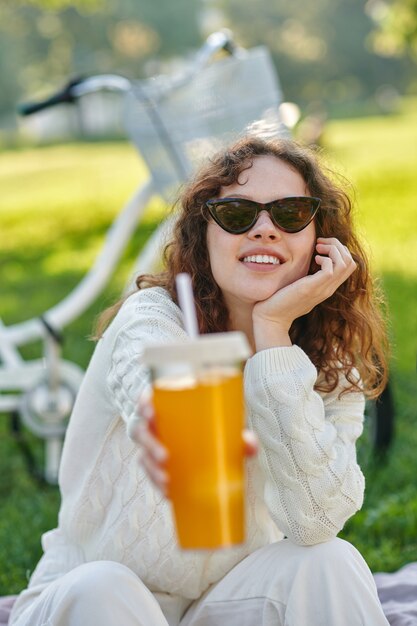 Premium Photo A Girl In White Sitting On A Grass In The Park And Looking Relaxed 6682