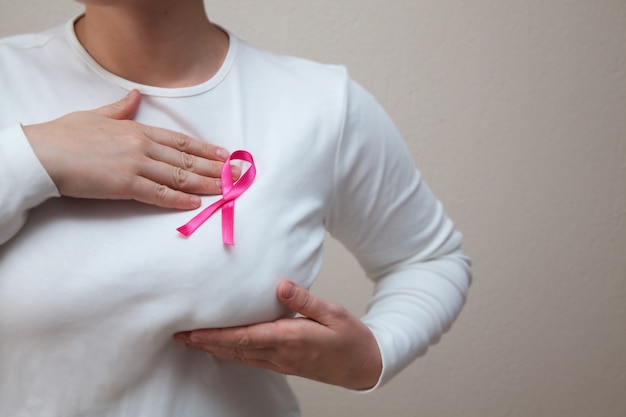 Premium Photo | Girl in a white t-shirt with a pink ribbon on her ...