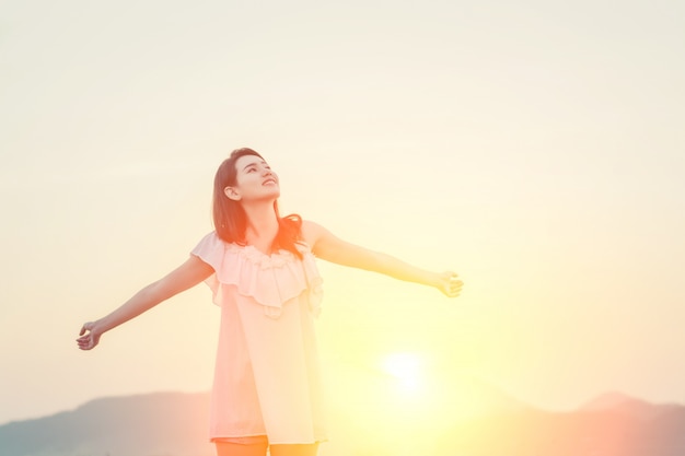 Girl with arms stretched and the sun behind Free Photo Girl with arms stretched and the sun behind Free Photo
