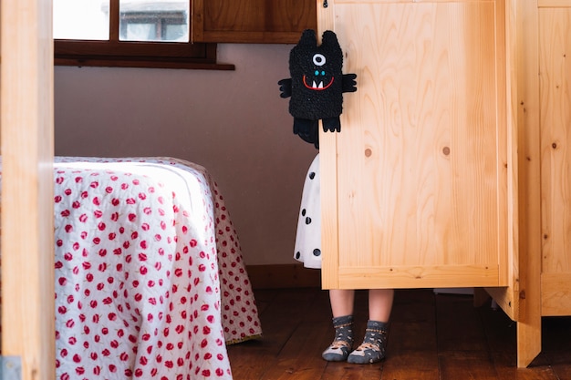 girl with black soft toy standing cupboard 23 2147824102