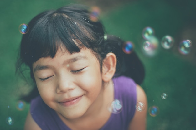 Girl with eyes closed and soap bubbles Photo | Free Download