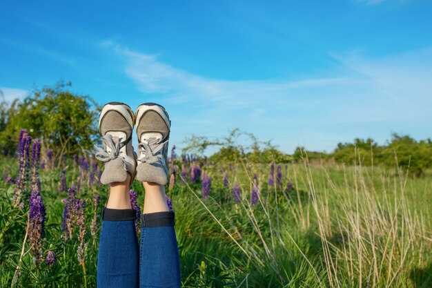 Premium Photo | Girl with her feet up in the field