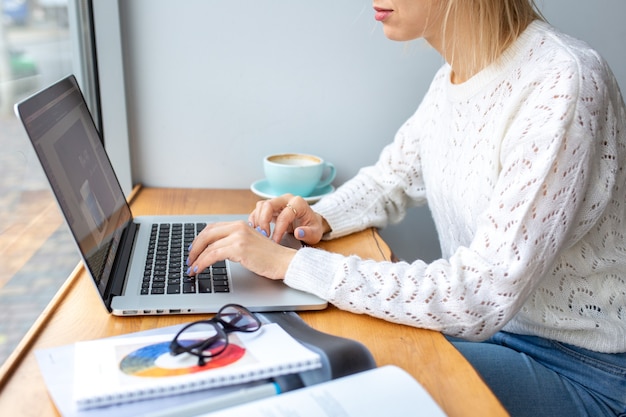 Premium Photo | The girl works from home at the computer with coffeethe