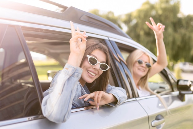 Free Photo | Girls going for a trip in their car